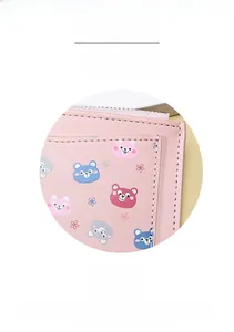 Close-up of pink PU leather wallet with cute bear patterns and smooth zipper texture