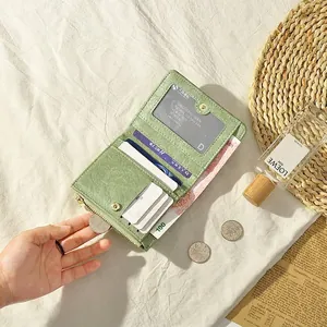 Short minimalist light green leather wallet for women with multiple card slots and coin pocket