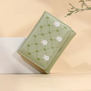 Short mint green bifold wallet with cute white rabbit print and peach pink lining