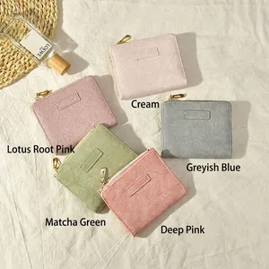 Short women's wallets in five colors including cream and pink with gold zippers