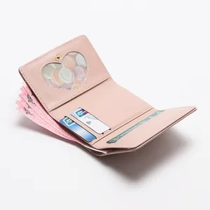Pink trifold wallet with heart-shaped ID window and card slots in premium leather