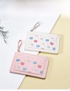 Pink and beige faux leather card holders with cartoon bear prints and wrist straps