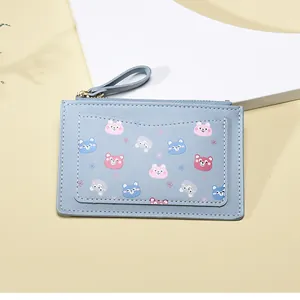 Close-up of light blue leather coin purse featuring colorful cartoon bear card slot detail