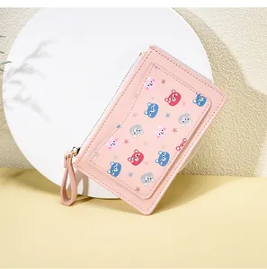 Close-up of pink zip-around wallet with cute cartoon bears and outer card slot