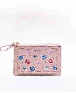 Front view of a pink cartoon coin purse with zipper and various colorful bear patterns