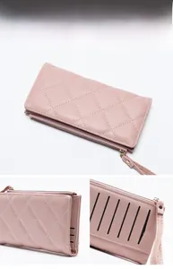 Detail view of pink quilted long wallet showing multiple card slots and tassel zipper