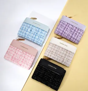 Detailed display of five tweed and leather wallets in assorted colors with zip closure
