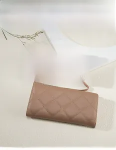 Quilted long wallets for women in black and beige with detachable wrist straps