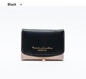 Close-up of black PU leather bifold wallet with pearl pendant and gold metal trim