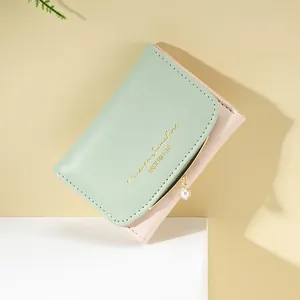 Short fold mint green and pink faux leather wallet with pearl charm and golden prints