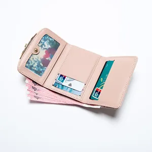 Pink tri-fold faux leather wallet for women with card slots and a photo window