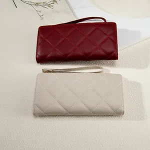 Quilted long leather wallet for women with wrist strap in dark red and beige colors