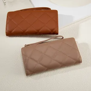 Quilted long wallets with wristlet strap in caramel brown and taupe faux leather