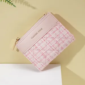 Pink short wallet for women featuring tweed texture and gold logo in a minimalist design