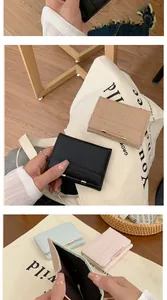 Dettaglio del portafoglio in pelle a motivo coccodrillo con fibbia dorata e slot per carte