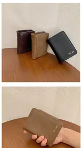Close-up of matte PU leather zip wallets in black and brown with reinforced corners