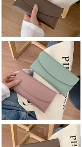 Detailed close-up of matte leather long envelope wallets in brown, green and pink tones