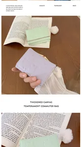 Detail of folding wallets in mint and lilac with heart embossing and plush pom-pom zip