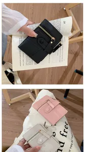 Detail of L-shaped zipper and snap closure on multi-color small leather wallets