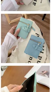 Detail view of compact bi-fold wallets in mint green and light blue premium PU leather
