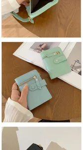 Detail of short leather wallet with multiple card slots and secure metal buckle closure