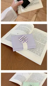Detail of lavender short wallet featuring a 3D checkered flower clasp on leather