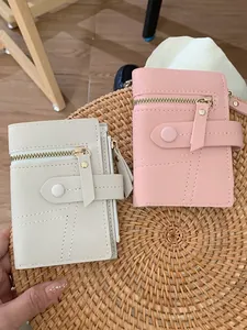 Short minimalist PU leather women wallet in beige and pink with gold zipper and stitching