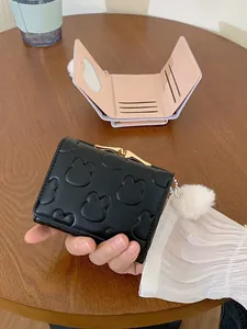 Women's black fold wallet with rabbit emboss, white pom-pom, and gold metal clasp