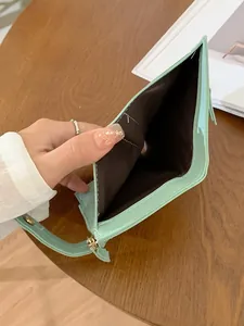 Women's minimalist mint green PU leather wallet with zipper closure and hand strap