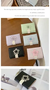 Short tri-fold card wallet with checkered floral clasp and long detachable shoulder strap