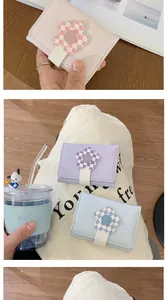 Close-up of pastel short wallets with checkered floral snaps and textured leather