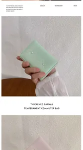 Detail of compact bow wallets with pearl accents in pale pink and green colors