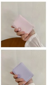 Close-up of minimalist mini trifold wallets with cute 3D flower detail in pink and purple