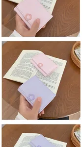 Detail of minimalist tri-fold mini wallet featuring a stylish 3D flower clasp and pastel colors