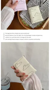 Détail de portefeuilles courts minimalistes avec broderie nuage et fermeture éclair en métal