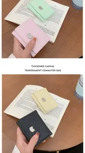Detail of colorful tri-fold wallets featuring cat embossing and metal bear clasps