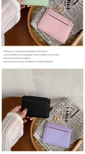 Detailed view of textured cowhide leather card holders with gold hardware and zippers