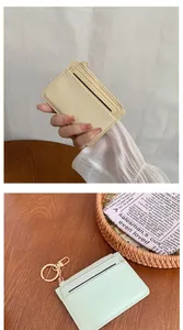 Detail of cream and mint green zipped card holders with vertical striped texture