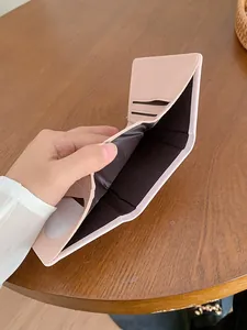 Pink PU leather short wallet for women featuring a bowknot and multiple card slots