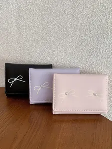 Cute women's bowknot wallet with pearl accent in pink, purple and black PU leather