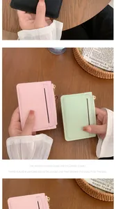 Close-up of textured card holders with metal zipper and premium striped stitching detail