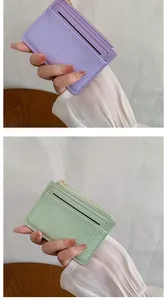 Close-up of minimalist textured PU leather card holders in purple and mint green colors