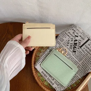 Vertical striped leather card holder wallet with zipper in cream yellow and mint green colors