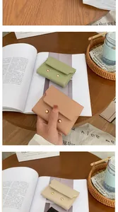 Detail of macaron leather wallets with envelope flap and double gold button closure