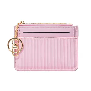 Pale pink minimalist zipper card holder wallet with vertical stripe texture and gold keychain