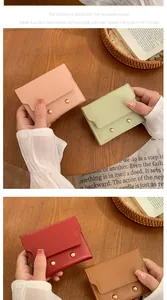 Detailed view of women's short lychee pattern wallets with elegant gold metal fasteners