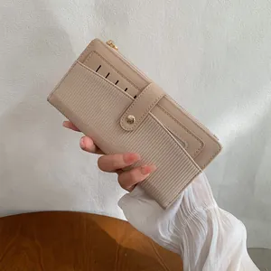 Portefeuille beige extra-plat pour femme avec texture rayée et fermeture éclair dorée