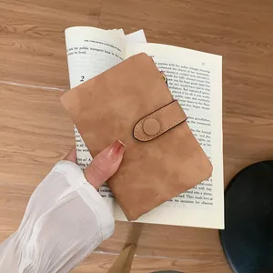 Minimalist camel suede short wallet for women featuring a snap button and compact design