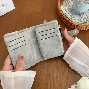 Gray suede minimalist multi-slot folding wallet with zipper pocket and metal snap closure