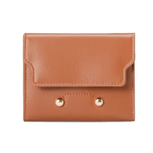 Brown textured leather bifold wallet for women featuring elegant gold ball decorative buckles